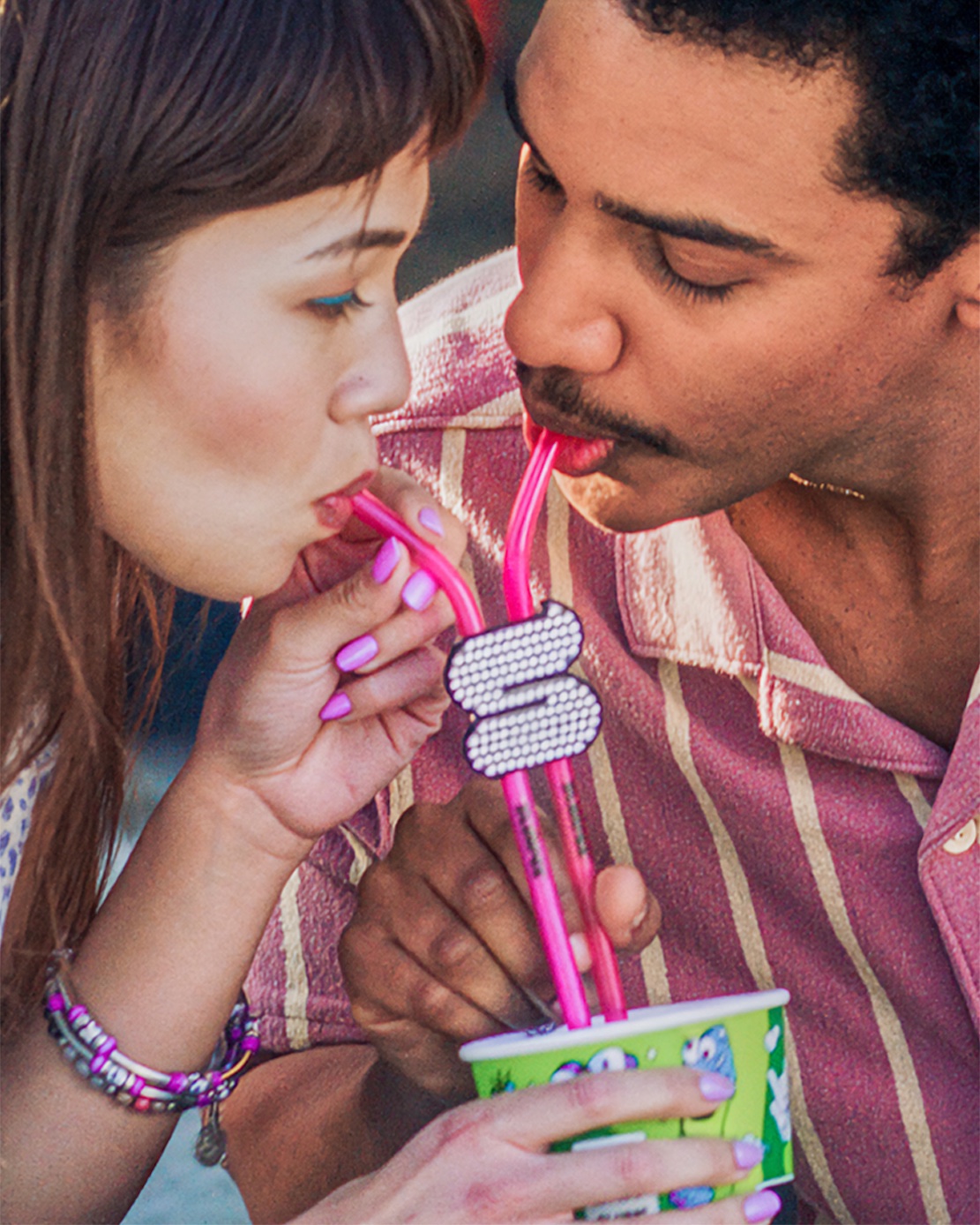 Couple sharing a Slurpee with the limited-edition double straw